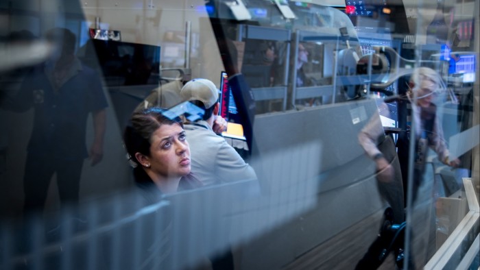 Traders on the floor of the New York Stock Exchange looking at their screens