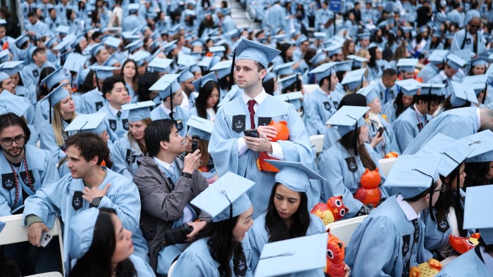 Students look on a wait for the start of the Commencement Ceremony at Columbia University