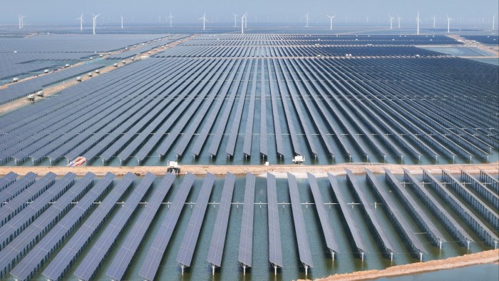 Solar panels and wind turbines are seen at the new Huaneng Binzhou power generation project in China’s eastern Shandong province in June 2025