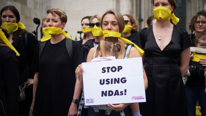 Campaigners from Can’t Buy My Silence and Pregnant Then Screwed, take part in a protest outside the Royal Courts of Justice, London