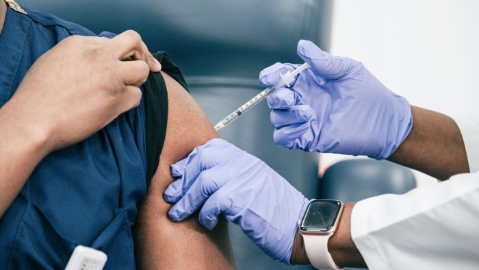 Healthcare worker gives a jab to a patient