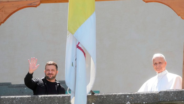 (L-R) Ukrainian President Volodymyr Zelenskyy and Pope Leo XIV wave to journalists during their meeting in Castel Gandolfo, Italy on July 9, 2025
