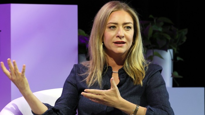 Whitney Wolfe Herd sitting on stage in a studio in May 2024