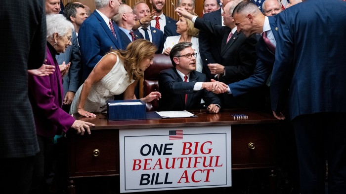 Republican House Speaker Mike Johnson, seated, shakes hand with fellow party member Rudy Yakym after passing the budget bill. It appears as though today’s leaders are hoping whoever follows them will do the hard work on reducing public debt