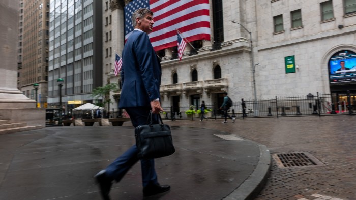 Man walks past the New York Stock Exchange