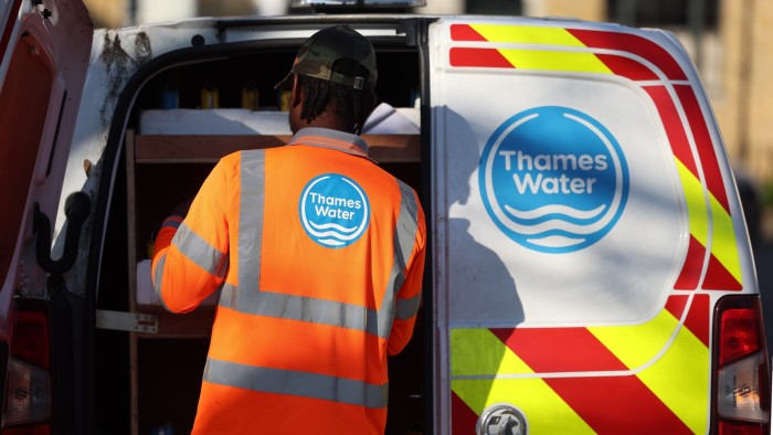 Man at back of van with Thames Water logo