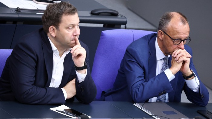 German chancellor Friedrich Merz sits next to finance minister Lars Klingbeil in the Bundestag on Friday