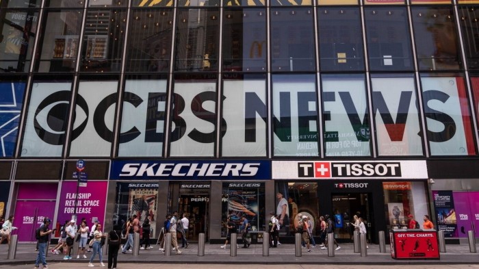 The exterior of 1515 Broadway in Times Square, New York, featuring prominent signage for CBS News, Skechers, and Tissot